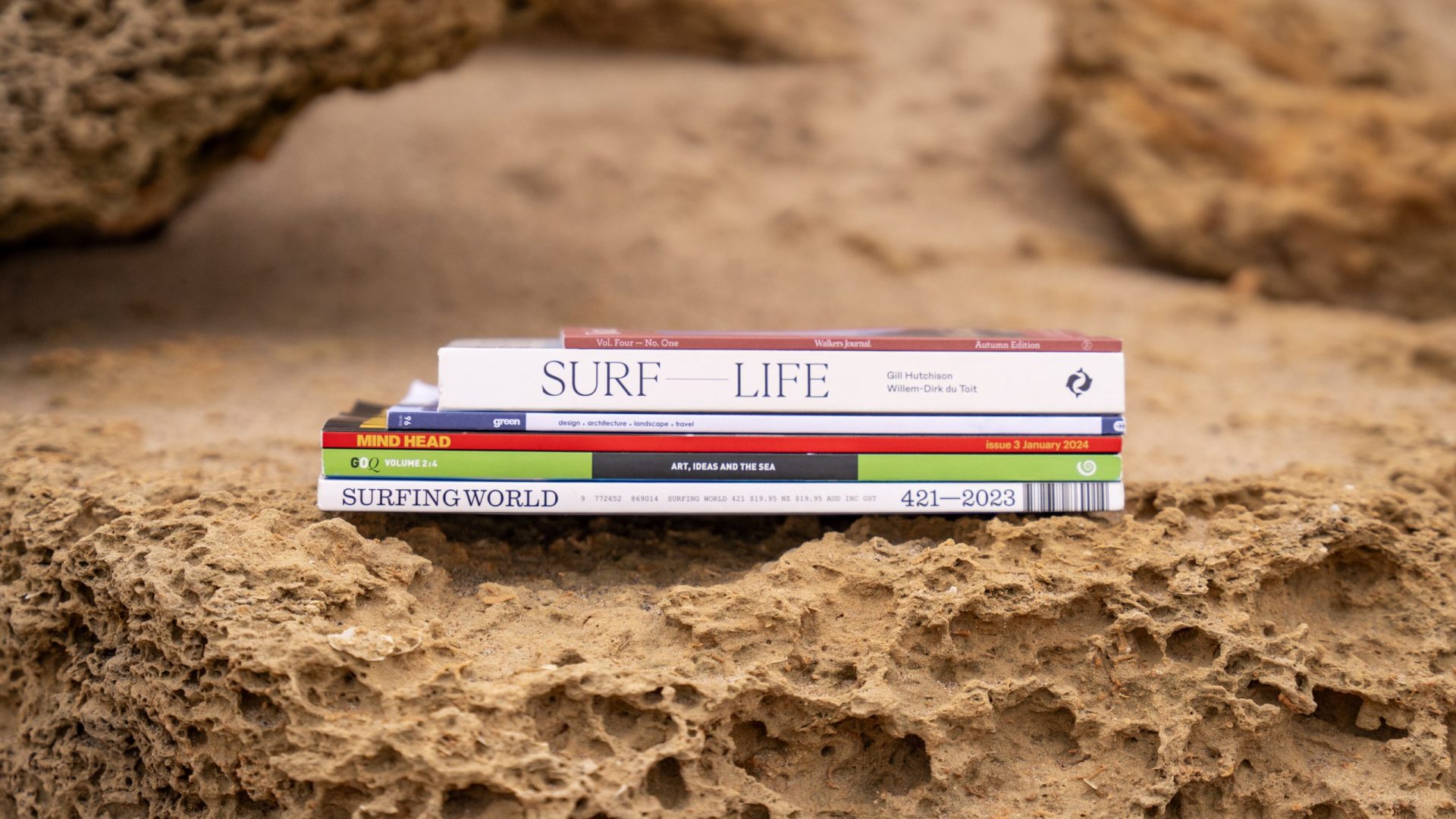 Artist books stacked on rock, Wadawurrung Country, photo by Ula Majewski.