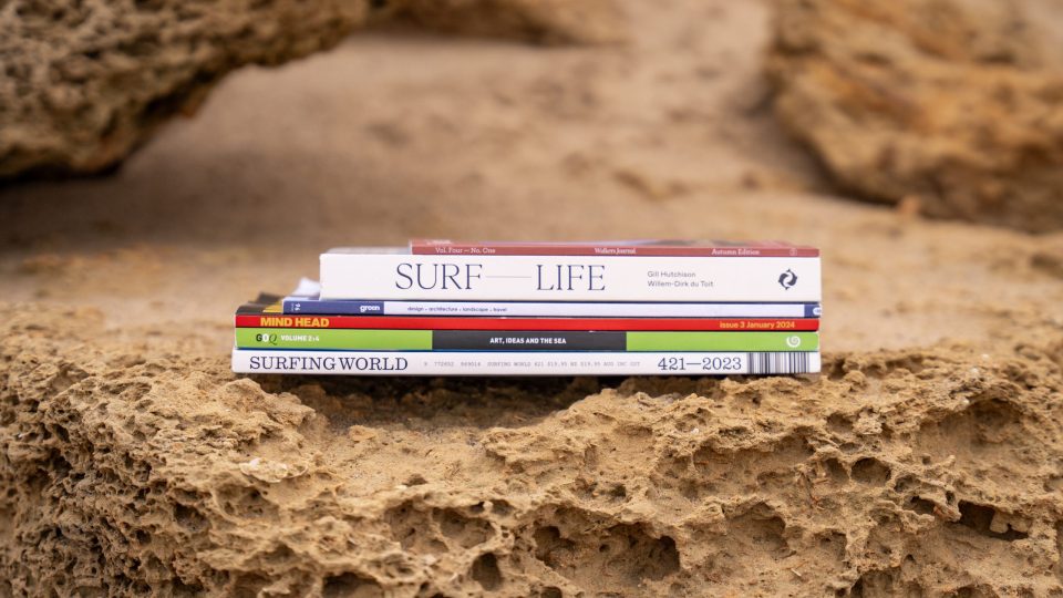 Artist books stacked on rock, Wadawurrung Country, photo by Ula Majewski.